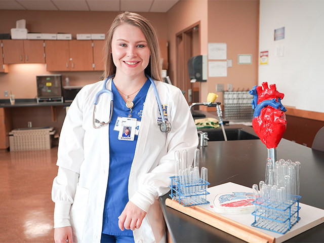 Female nursing student in a white lab coat